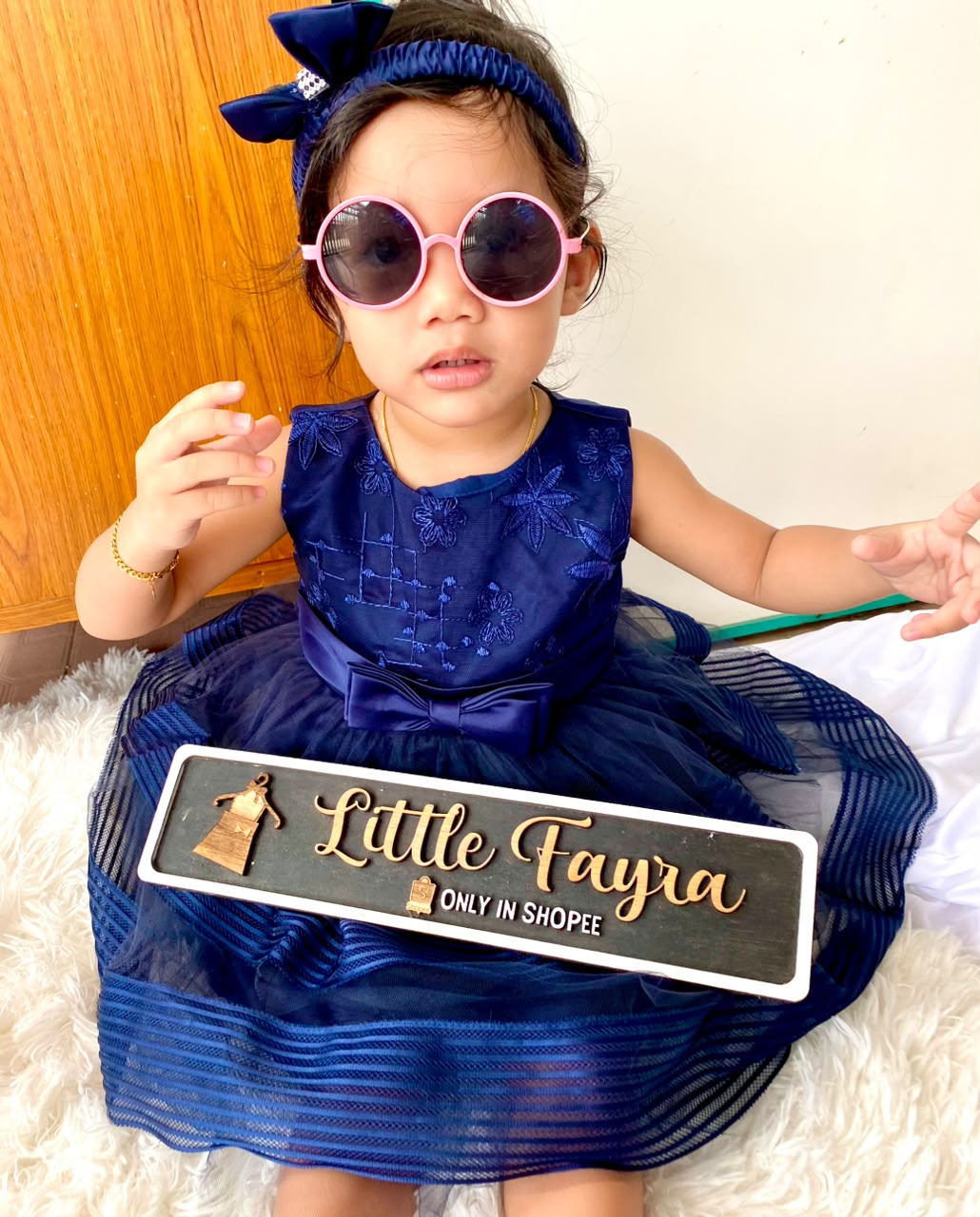 Aisyah wearing a blue Little Fayra dress